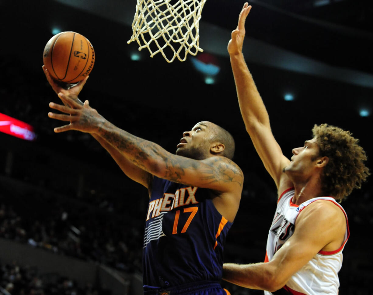 Phoenix Suns small forward P.J. Tucker (17) drive to the basket against Portland Trail Blazers center Robin Lopez Nov. 13 in Portland.