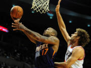 Phoenix Suns small forward P.J. Tucker (17) drive to the basket against Portland Trail Blazers center Robin Lopez Nov. 13 in Portland.