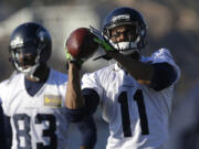 Seattle Seahawks wide receiver Percy Harvin (11) catches the football during warm-up drills before practice on Thursday in Renton. The Seahawks will play the Denver Broncos Feb. 2, 2014 in the Super Bowl. (AP Photo/Ted S.