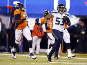 Seattle Seahawks' Malcolm Smith (53) on his way to a 69-yard interception return for a touchdown in the second quarter.