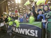 Fans greet Seattle Seahawks players and coaches during the team's arrival at Seattle-Tacoma International Airport on Monday after the team's Super Bowl victory.