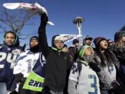 Seattle Seahawks fans cheer as they wait for the Seahawks' Super Bowl victory parade to begin Wednesday in Seattle.