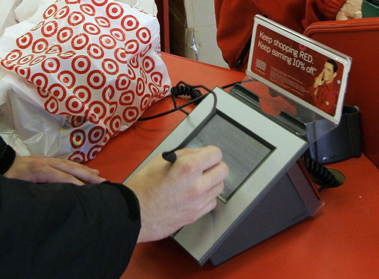 A customer signs his credit card receipt at a Target store in Tallahassee, Fla., on Jan. 18, 2008. Target says that about 40 million credit and debit card accounts customers may have been affected by a data breach that occurred at its U.S. stores between Nov. 27, 2013, and Dec.