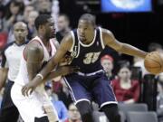 Oklahoma City's Kevin Durant is defended by Portland's Wesley Matthews on Tuesday.