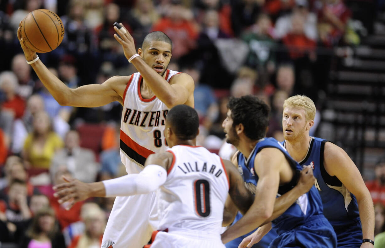 Minnesota Timberwolves' Ricky Rubio (9) defends as Portland Trail Blazers' Nicolas Batum (88) looks to pass during the first half of an NBA basketball game in Portland, Ore., Sunday Feb. 23, 2014.