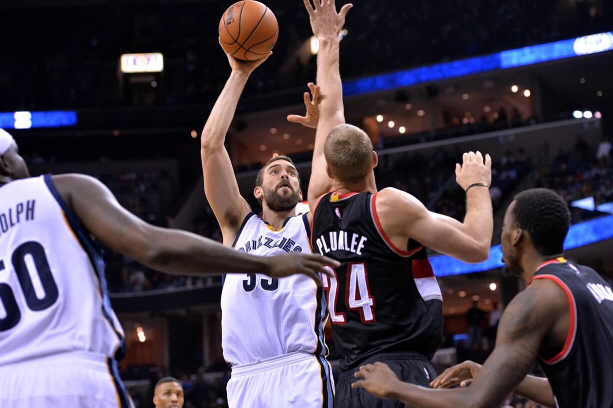 Memphis Grizzlies center Marc Gasol (33) shoots against Portland Trail Blazers center Mason Plumlee (24) in the first half of an NBA basketball game Friday, Nov. 13, 2015, in Memphis, Tenn.