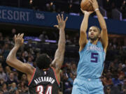 Charlotte Hornets' Nicolas Batum shoots over Portland Trail Blazers' Cliff Alexander during the first half of an NBA basketball game in Charlotte, N.C., Sunday, Nov. 15, 2015.