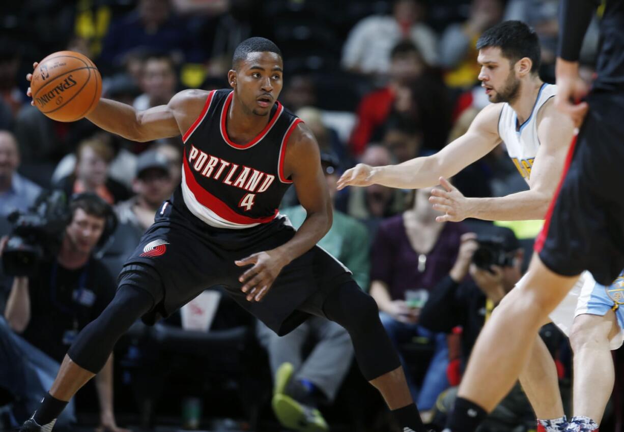 Portland Trail Blazers forward Maurice Harkless, left, pulls in the ball as Denver Nuggets forward Kostas Papanikolaou defends in the second half of an NBA basketball game Monday, Nov. 9, 2015, in Denver. The Nuggets won 108-104.