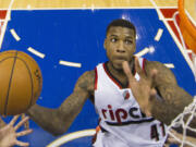 Portland Trail Blazers' Thomas Robinson goes up to shoot during the first half of an NBA basketball game against the Philadelphia 76ers, Saturday, Dec. 14, 2013, in Philadelphia.