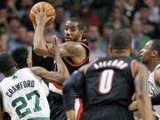 Portland Trail Blazers forward LaMarcus Aldridge, second from left, looks to pass while covered by Boston Celtics guard Jordan Crawford (27) and Jared Sullinger, right, during the second quarter Friday.