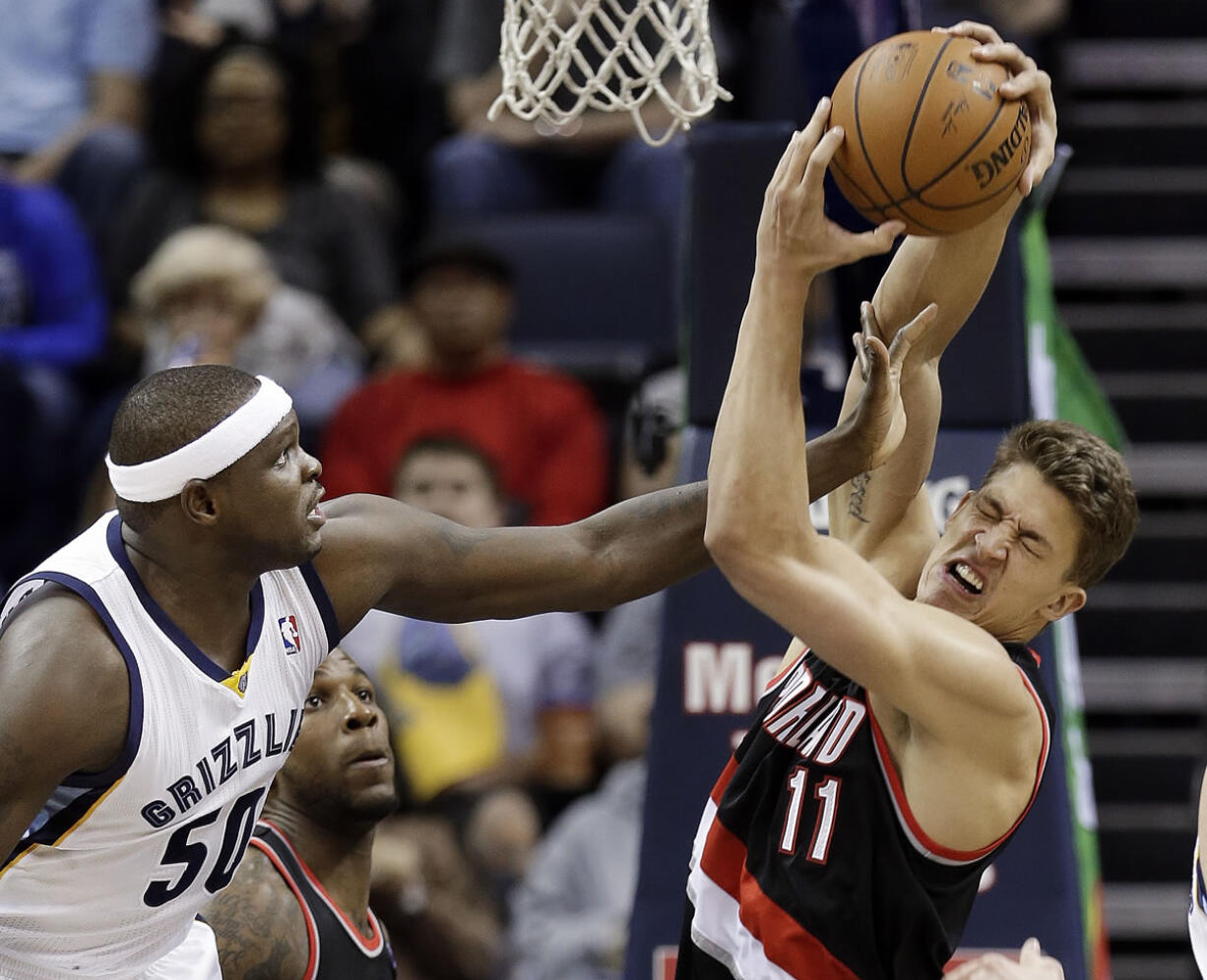 Portland Trail Blazers center Meyers Leonard (11) gets a hand in the face from Memphis Grizzlies forward Zach Randolph (50) in the first half Tuesday in Memphis, Tenn.