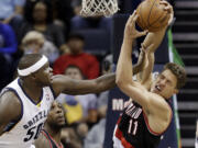 Portland Trail Blazers center Meyers Leonard (11) gets a hand in the face from Memphis Grizzlies forward Zach Randolph (50) in the first half Tuesday in Memphis, Tenn.