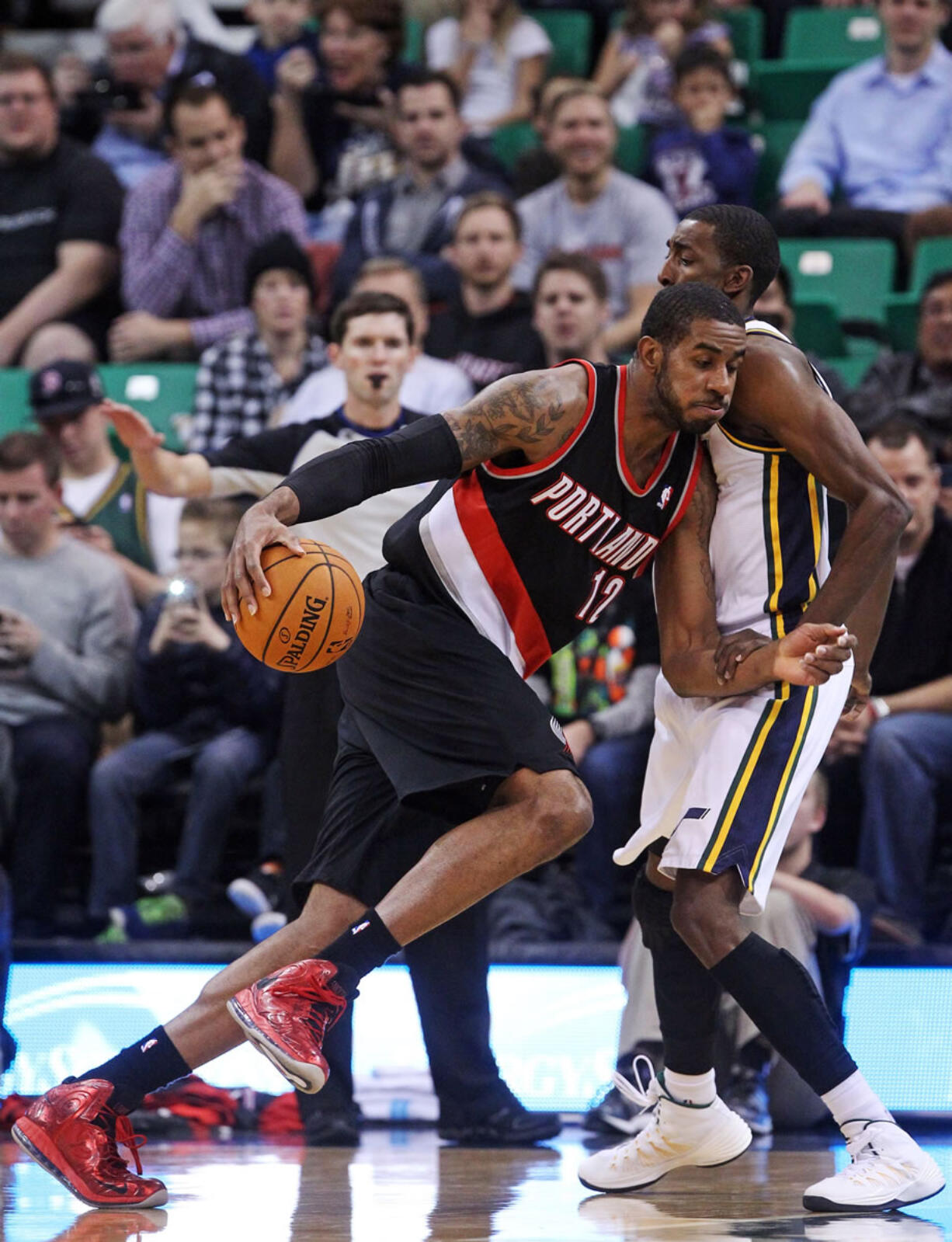 Portland Trail Blazers' LaMarcus Aldridge (12) drives on Utah Jazz's Jeremy Evans, right, in the first quarter  Monday at Salt Lake City.