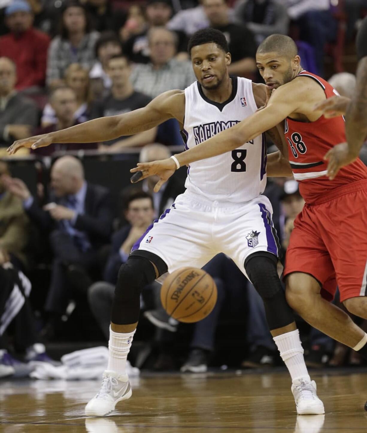 Sacramento Kings forward Rudy Gay, left, and Portland Trail Blazers forward Nicolas Batum, right, battle for the ball during the first quarter in Sacramento, Calif., Tuesday.