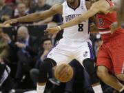 Sacramento Kings forward Rudy Gay, left, and Portland Trail Blazers forward Nicolas Batum, right, battle for the ball during the first quarter in Sacramento, Calif., Tuesday.