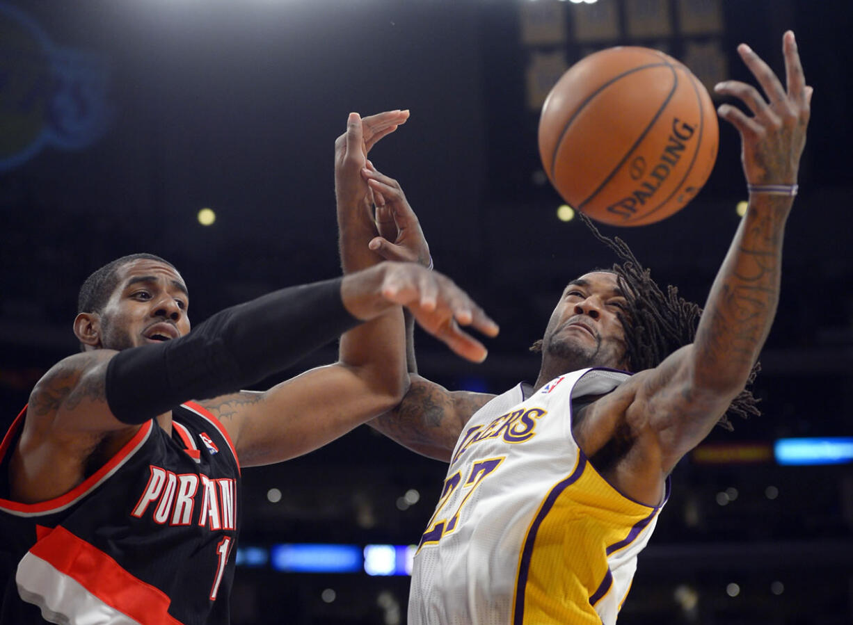 Portland Trail Blazers forward Dorell Wright, left, and Los Angeles Lakers center Jordan Hill battle for a rebound during the first half Sunday in Los Angeles.