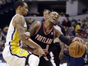 Portland Trail Blazers guard Damian Lillard, right, works against Indiana Pacers guard George Hill during the first half at Indianapolis on Friday.