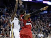 New Orleans' Tyreke Evans (1) shoots the game-winning shot over Portland's Mo Williams (25) in the final seconds of Monday's game.