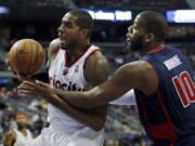 Portland Trail Blazers forward LaMarcus Aldridge, left, is fouled by Detroit Pistons center Greg Monroe (10) while going to the basket during the second half Sunday.