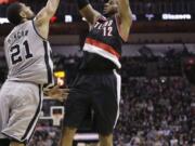 Portland's LaMarcus Aldridge (12), shooting over San Antonio's Tim Duncan during Friday's win, has had a solid first half of the season for the Trail Blazers.