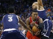 Portland Trail Blazers guard Damian Lillard drives between Oklahoma City Thunder forward Perry Jones (3) and guard Derek Fisher (6) during a recent game.