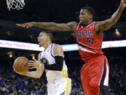 Golden State Warriors' Stephen Curry (30) drives past Portland Trail Blazers' Thomas Robinson (41) during the second half of an NBA basketball game on Sunday, Jan. 26, 2014, in Oakland, Calif. Golden State won 103-88.