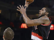 Portland Trail Blazers' LaMarcus Aldridge (12) shoots over Golden State Warriors' David Lee during the first half of an NBA basketball game Saturday, Nov. 23, 2013, in Oakland, Calif.