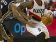 Portland Trail Blazers Damian Lillard drives past San Antonio's Tony Parker at the Moda Center, Saturday, November 2, 2013.