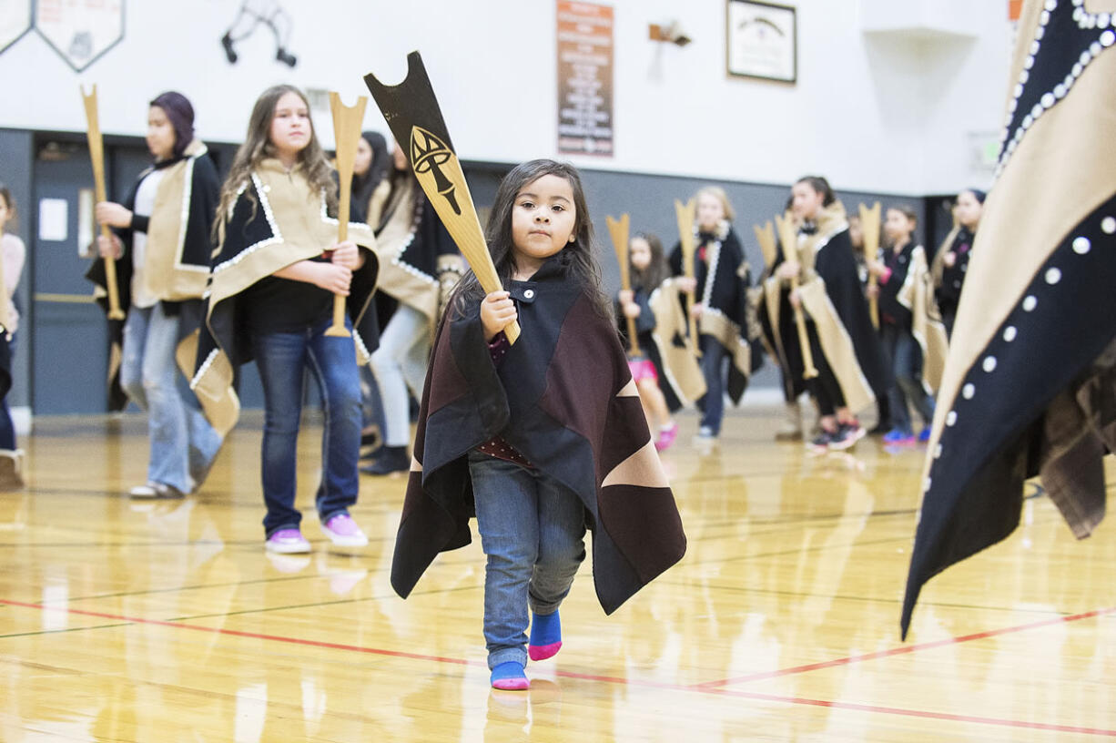 Jayde Diaz and other members of the Canoe family dance Nov. 16 during the Grand Ronde tribal flag posting ceremony at the high school gym in Willamina, Ore.