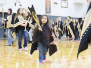 Jayde Diaz and other members of the Canoe family dance Nov. 16 during the Grand Ronde tribal flag posting ceremony at the high school gym in Willamina, Ore.