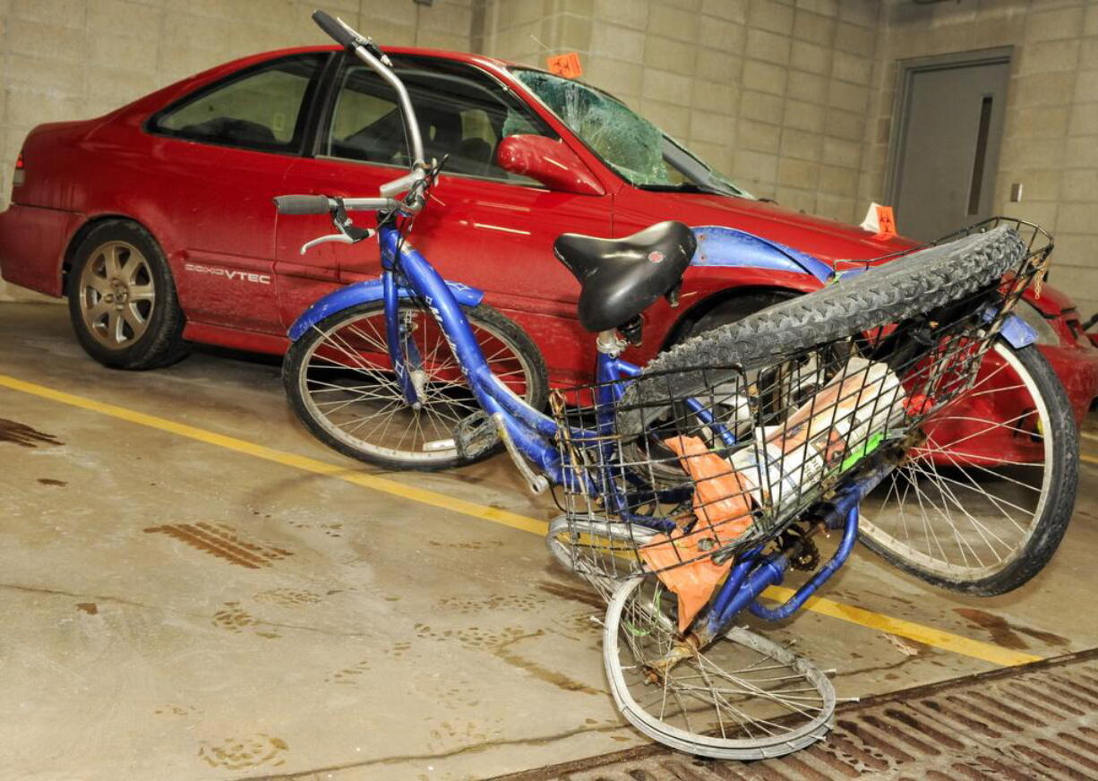 Steven Gove's three-wheeled tricycle and the car that hit him Saturday night at the Manitowoc, Wis., Police Station.