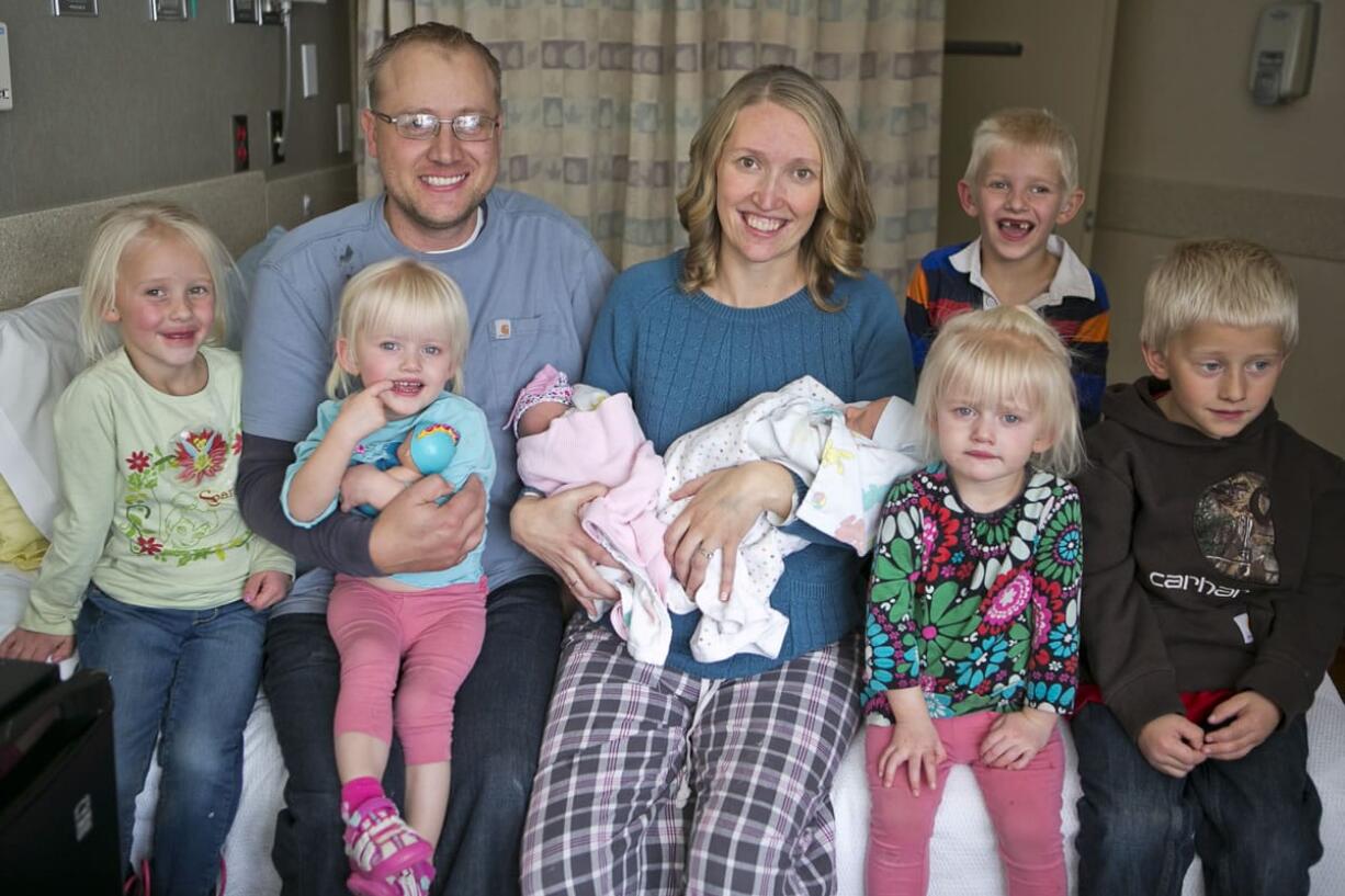 Tiffany and Chris Goodwin of Three Forks, Mont., pose for a family photo Wedmesdau with their children, from left, Eliza, Brielle, Olivia, Carter, Mason, Emalynn and Josh at the Bozeman Health Deaconess Hospital in Bozeman, Mont. Tiffany gave birth to her third set of twins, Olivia and Carter, on Monday.