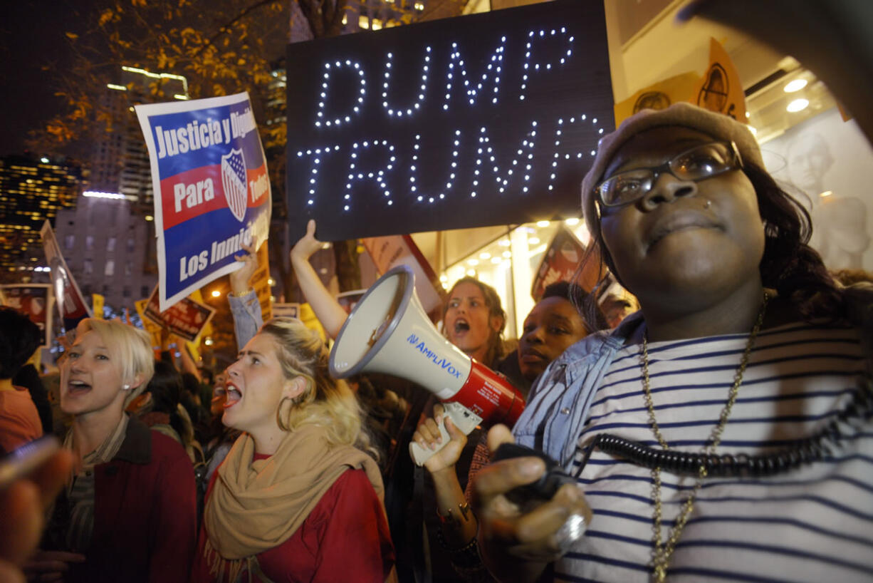 Sasha Murphy of the ANSWER Coalition leads demonstrators in a chant during a protest against Republican presidential candidate Donald Trump's hosting "SNL" Saturday night in New York. Despite a 40-year history of lampooning politicians while inviting some to mock themselves as on-air guests, booking a presidential candidate to host the NBC sketch-comedy show is almost unprecedented.