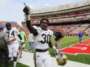 FILE - In this Sept. 14, 2013, file photo, UCLA linebacker Myles Jack (30) celebrates a 41-21 win over Nebraska in an NCAA college football game in Lincoln, Neb. Although Myles Jack is one of the nation's top young linebackers, it turns out the UCLA freshman is also pretty good with the ball in his hands. Jack gained 120 yards in just six carries against Arizona, and the 13th-ranked Bruins just might put him back in the backfield Friday against Washington.