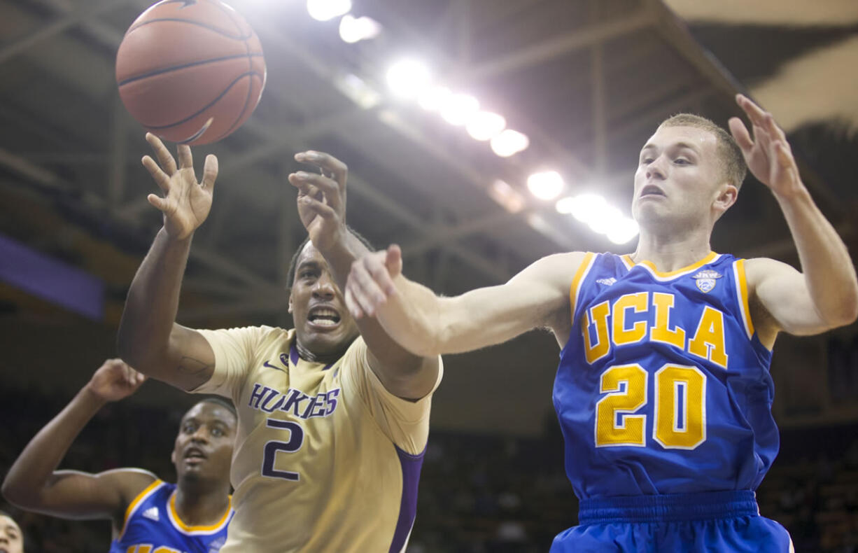 Washington's Perris Blackwell (2) battles with UCLA's Bryce Alford for a loose ball in the second half of an NCAA college basketball game on Thursday March 6, 2014, in Seattle. UCLA won 91-82.