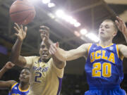 Washington's Perris Blackwell (2) battles with UCLA's Bryce Alford for a loose ball in the second half of an NCAA college basketball game on Thursday March 6, 2014, in Seattle. UCLA won 91-82.