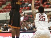 Southern California guard Byron Wesley (22) scores on this 3-point shot over Washington State guard DaVonte Lacy (25) during the first half of an NCAA college basketball game Thursday, March 6, 2014, at Beasley Coliseum in Pullman, Wash.