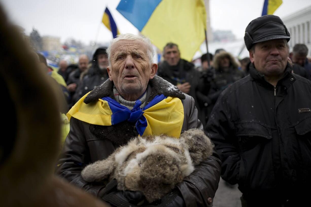 A Pro-European Union activist listens to a speaker at Independence Square in Kiev, Ukraine, on Tuesday.