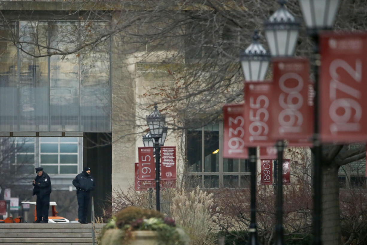 Campus security officers on the Main Quadrangles at the University of Chicago in Chicago on Monday The University of Chicago announced Sunday that all classes and other activities planned for Monday on its Hyde Park campus will be canceled after the university was informed by FBI counterterrorism officials of a gun violence threat to the campus. (Jose M.