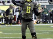 Oregon quarterback Marcus Mariota throws for a touchdown against Utah.