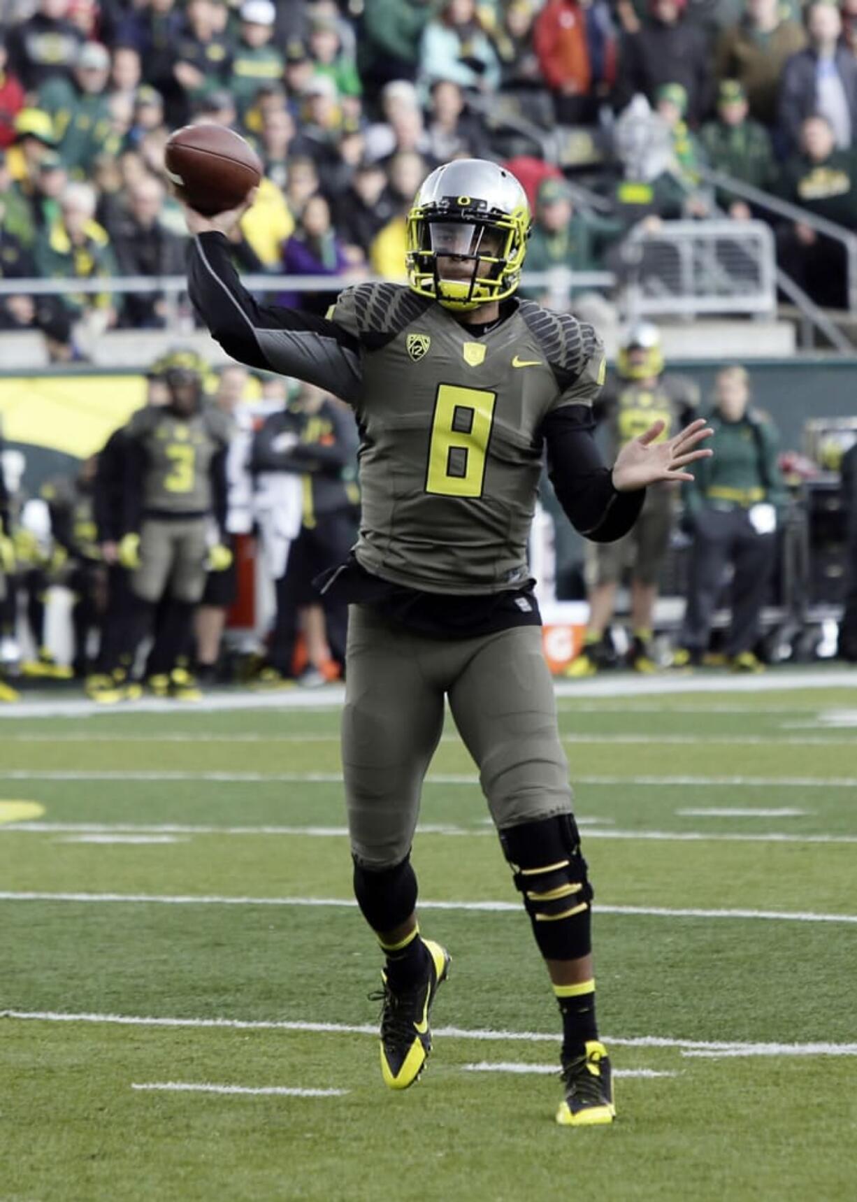 Oregon quarterback Marcus Mariota throws for a touchdown against Utah.