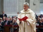 In this photo taken on Sept.19, 2013 provided by the Vatican newspaper L'Osservatore Romano, Vatican Almoner, Archbishop Konrad Krajewski attends the ceremony for his episcopal ordination, in St. Peter's Basilica, at the Vatican. The existence of the Vatican Almoner dates back centuries: It is mentioned in a papal bull from the 13th-century Pope Innocent III, and Pope Gregory X, who ruled from 1271-1276, organized it into an official Holy See office for papal charity. Up until Krajewski came along, the almoner was typically an aging Vatican diplomat who was serving his final years before being allowed to retire at age 75. Francis changed all that, tapping the 50-year-old Pole to be a more vigorous, hands-on extension of himself. The almoner's duties are two-fold: carrying out acts of charity, and raising the money to fund them.