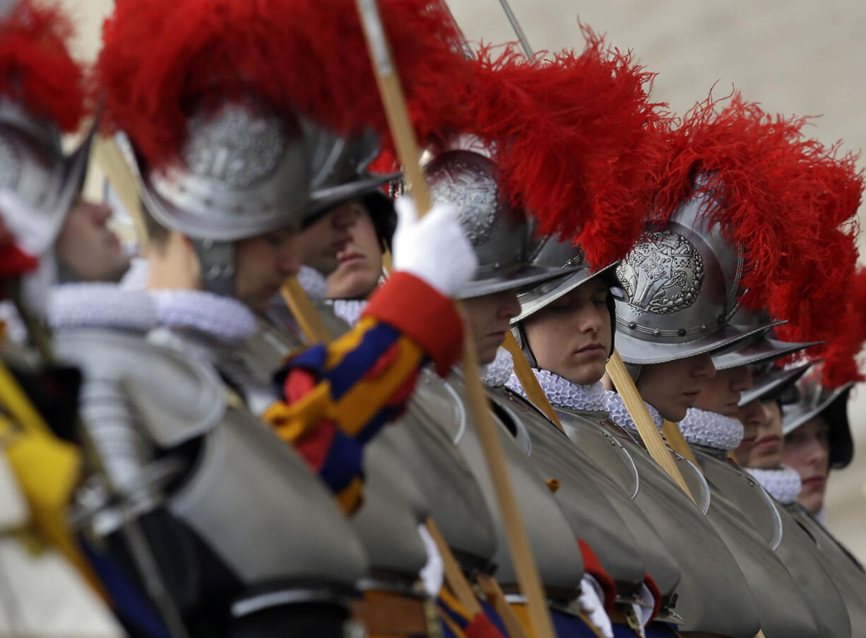 Swiss guards get ready prior to the start of Pope Francis &quot;Urbi et Orbi&quot; (to the City and to the World) message he delivered from the central balcony of St.