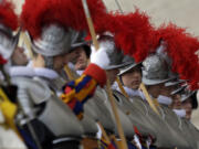 Swiss guards get ready prior to the start of Pope Francis &quot;Urbi et Orbi&quot; (to the City and to the World) message he delivered from the central balcony of St.