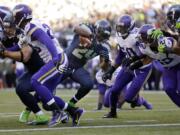 Seattle Seahawks' Marshawn Lynch (24) finds a hole as he heads to score against the Minnesota Vikings in the first half of an NFL football game Sunday, Nov. 17, 2013, in Seattle. (AP Photo/Ted S.