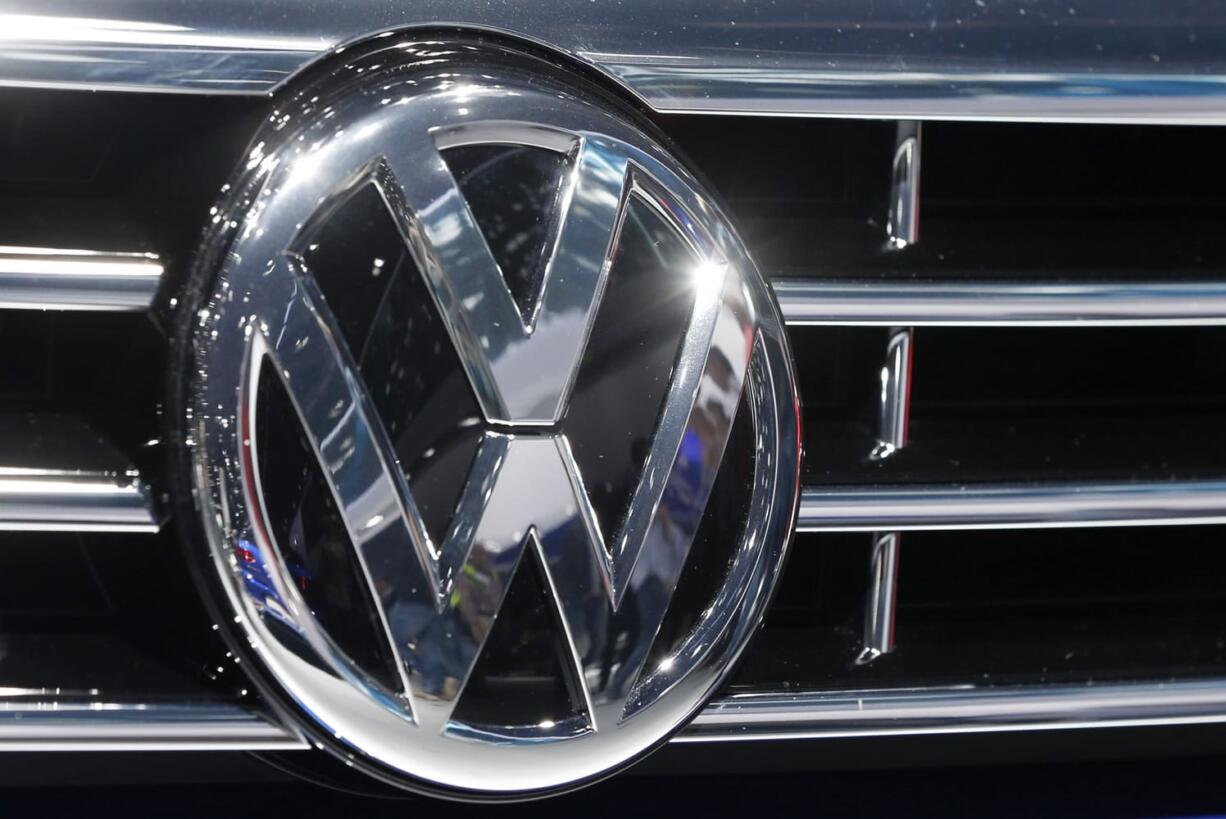 The Volkswagen logo of a car is photographed during a car show in Frankfurt, Germany. A dealer familiar with Volkswagen&#039;s plans says the automaker intends to offer $1,000 in gift cards and vouchers to owners of smaller diesel cars as a gesture of goodwill to owners with 2-liter four-cylinder diesel engines that have been implicated in an emissions cheating scandal.