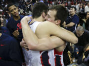 Gonzaga's Kevin Pangos, right, hugs Drew Barham after Gonzaga defeated BYU in the WCC title game.