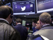 Traders gather at the post that handles Twitter on the floor of the New York Stock Exchange on Nov.