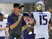 Washington head coach Chris Petersen applauds his players after a touchdown against Arizona State during the first half of an NCAA college football game Saturday, Nov. 14, 2015, in Tempe, Ariz. (AP Photo/Ross D.