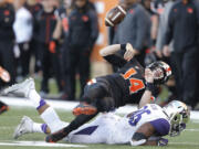 Oregon State quarterback Nick Mitchell fumbles the ball after being hit by Washington&#039;s Azeem Victory in the first half of an NCAA football game, in Corvallis, Ore., on Saturday, Nov. 21, 2015. Washington recovered the fumble. y(AP Photo/Timothy J.